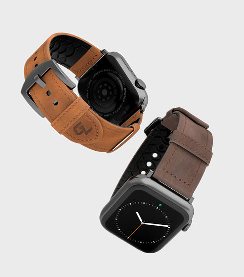 two apple watches, one with a tan band and one with a brown band