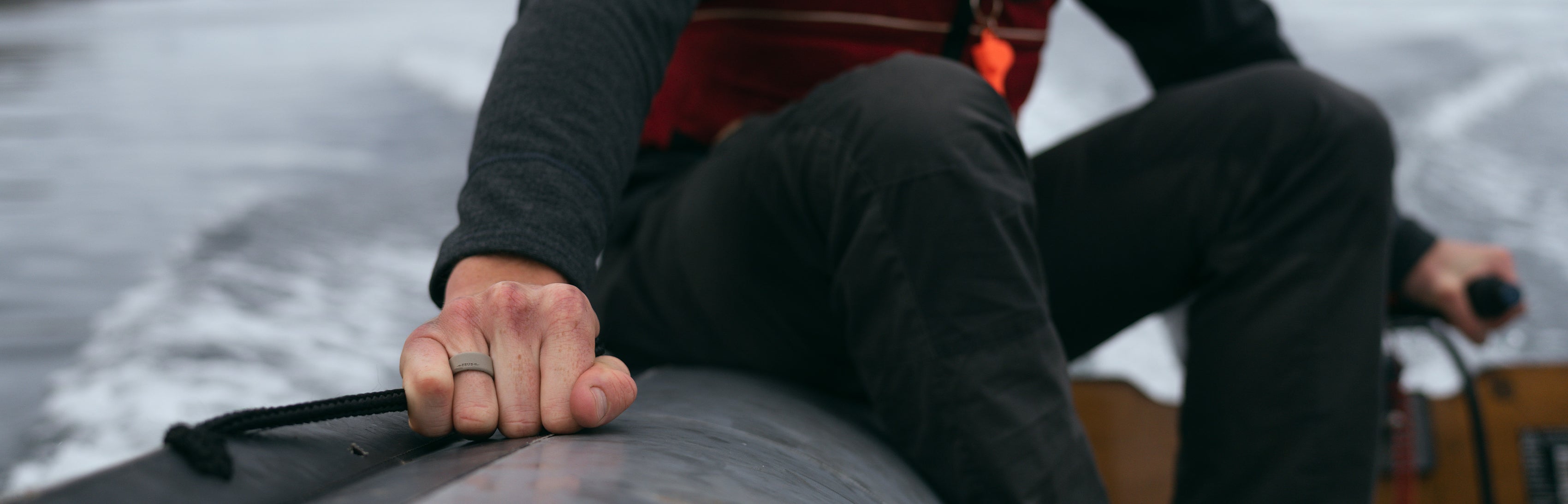 man riding a boat wearing a Groove Life Zeus ring