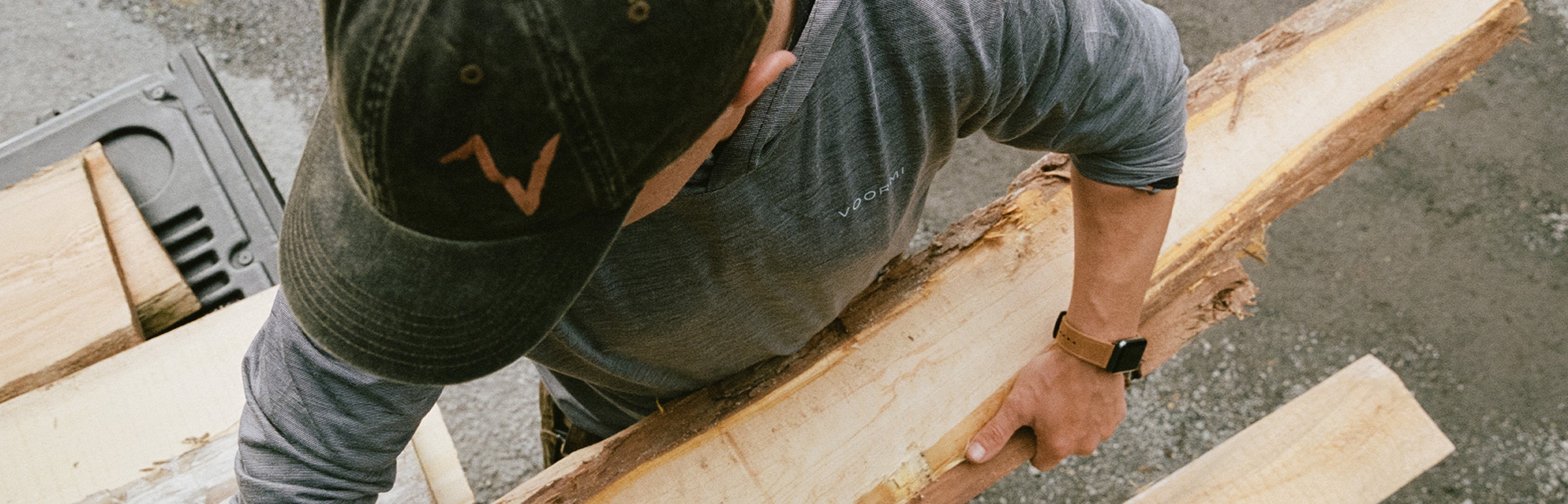 man carrying a plank of wood wearing a Groove Life watch band