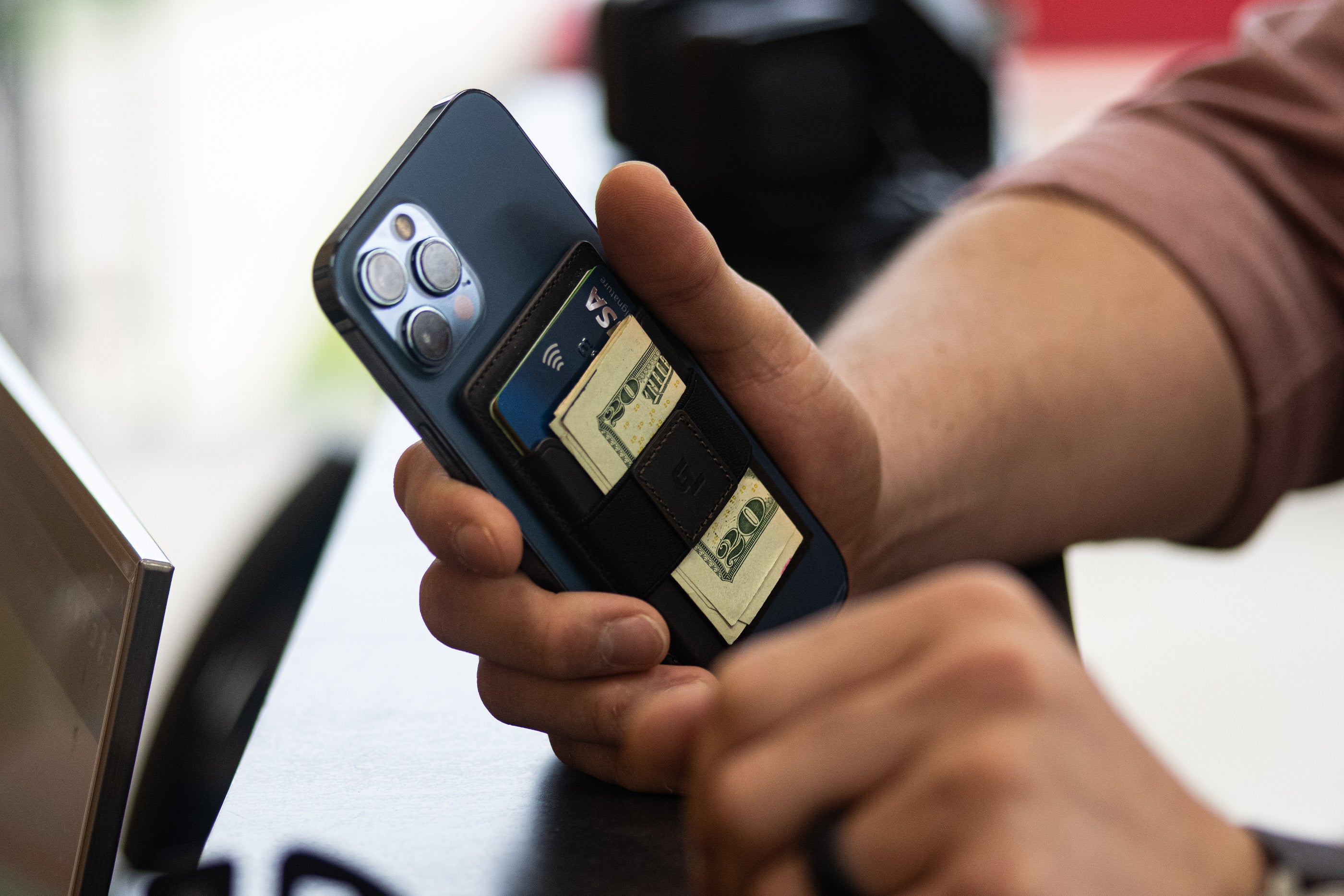 Lifestyle Image of a man holding a Groove Wallet Go